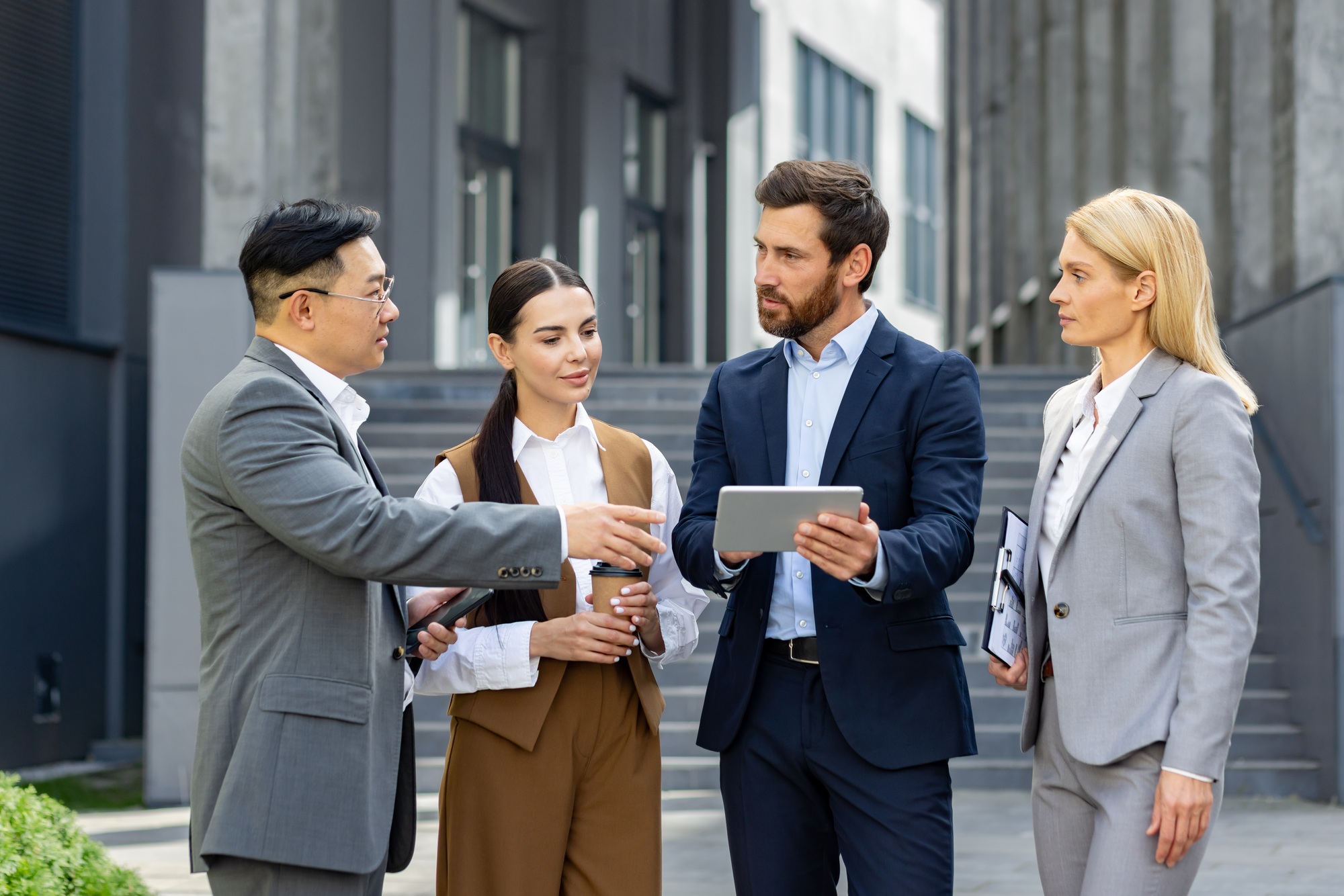 Professional team discussing business strategy outdoors